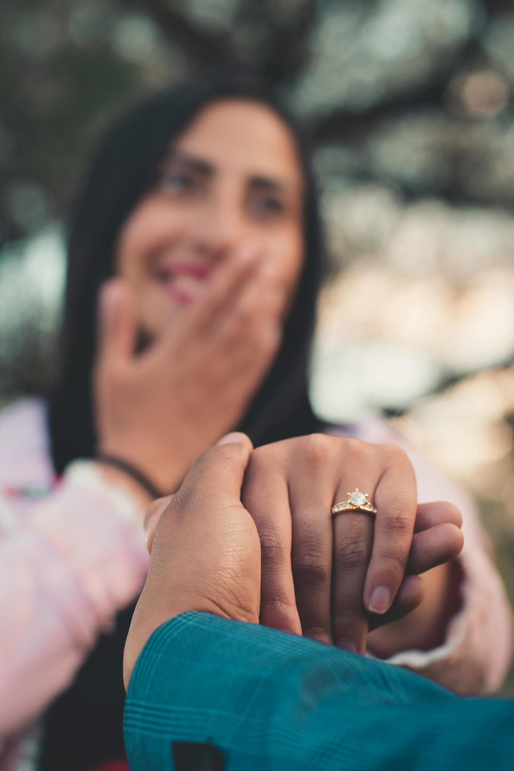 A joyful couple during a romantic outdoor engagement proposal.